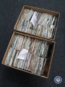 Two boxes containing 7" singles including The Beatles, Elvis Presley, Bob Marley,