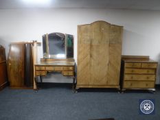 An early 20th century walnut three piece bedroom suite comprising of single door wardrobe,