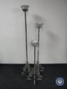 A set of three graduated wrought iron candle stands with glass drops