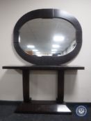 A contemporary console table and mirror in a rosewood finish