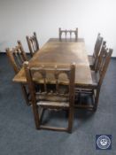 An early 20th century oak refectory pullout dining table together with a set of six oak Gothic