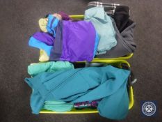 Two plastic tubs containing a large quantity of assorted clothing including raincoat,
