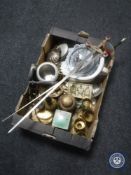 A tray containing assorted metal ware, two ornamental swords,