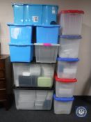 Thirteen plastic storage crates (twelve with lids),