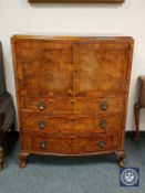 A burr walnut bowfront cabinet fitted three drawers,