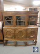 A carved oak Lees style triple door sideboard