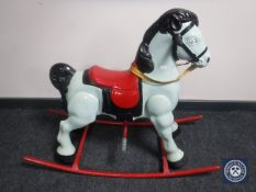 A mid 20th century hand painted tin plate rocking horse