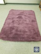 A contemporary shaggy pile rug on purple ground,