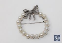 A 14ct white gold pearl and diamond set brooch