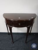 A mahogany D-shaped hall table fitted a drawer on Queen Anne legs