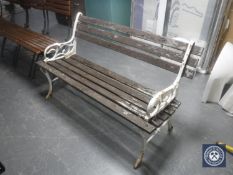 A wrought iron and wooden garden bench