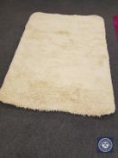 A contemporary shaggy pile rug on cream ground,