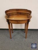 A reproduction mahogany oval writing table,