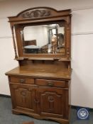 An Arts & Crafts oak mirror back sideboard,