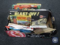 A box containing Waddingtons blast off, Batman Swoops Down, Tarzan,