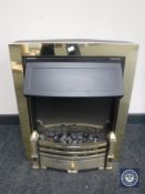 A brass framed coal effect electric fire