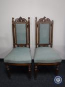 A pair of Edwardian oak dining chairs