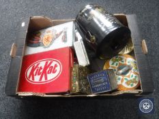 A box containing a collection of vintage tins