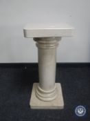 A marble column plant pedestal