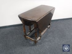 An early 20th century oak gate leg table
