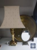 A circular folding Eastern brass table together with a brass table lamp with shade and a gilt metal