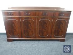 An inlaid mahogany Regency style four door sideboard