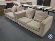 A pair of beige cloth two seater settees on chrome legs
