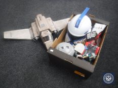 A box of assorted Star Wars ships, Storm Trooper helmets,