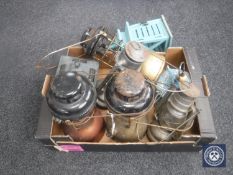 A box of vintage Tilley lamps and lanterns