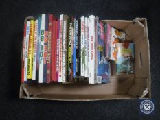 A box containing mid 20th century annuals and paperback books including Thunderbirds, Joe 90,