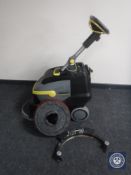 A Karcher Professional BD38/12C floor cleaner with brush pads