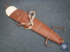 A brown leather shotgun soft carry case