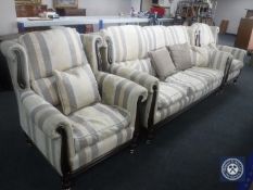 A three piece wingback lounge suite upholstered in a striped print