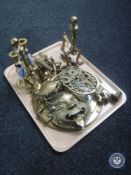 A tray of assorted brass ware including fire dogs, porthole mirror, trivet,