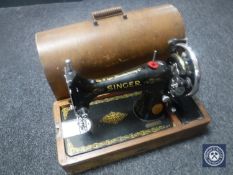 A mid 20th century oak cased Singer hand sewing machine