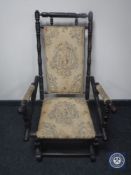 A mahogany framed tapestry upholstered American style rocking chair