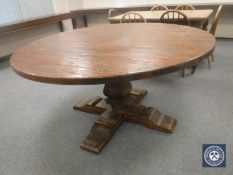 A circular oak pedestal dining table