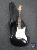 An Encore electric guitar in carry bag