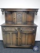A carved oak 20th century court cupboard