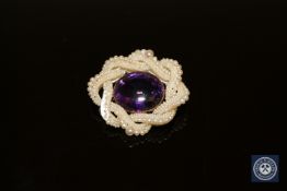A Victorian amethyst and pearl brooch in gold mount