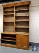 A Victorian oak bookcase fitted with a panelled cupboard below, width 201 cm,