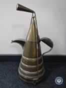 An Eastern brass teapot on warming stand