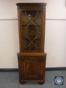 A mahogany corner display cabinet