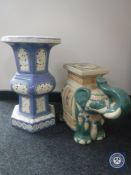 A glazed pottery elephant plant stand together with one other