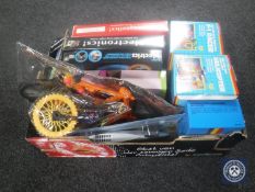 A box containing assorted toys including electronic kits,