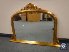 A gilt framed Victorian style overmantel mirror