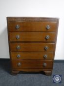 A 20th century oak five drawer chest