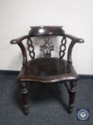 An antique oak captain's armchair