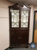 A George III glazed mahogany corner cupboard,