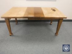 An Edwardian oak wind out dining table with two leaves CONDITION REPORT: This